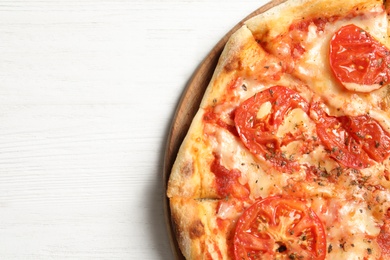 Photo of Hot cheese pizza Margherita on white wooden background, top view. Space for text