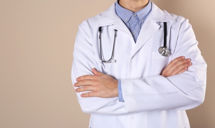 Photo of Young medical student in uniform on color background, closeup. Space for text