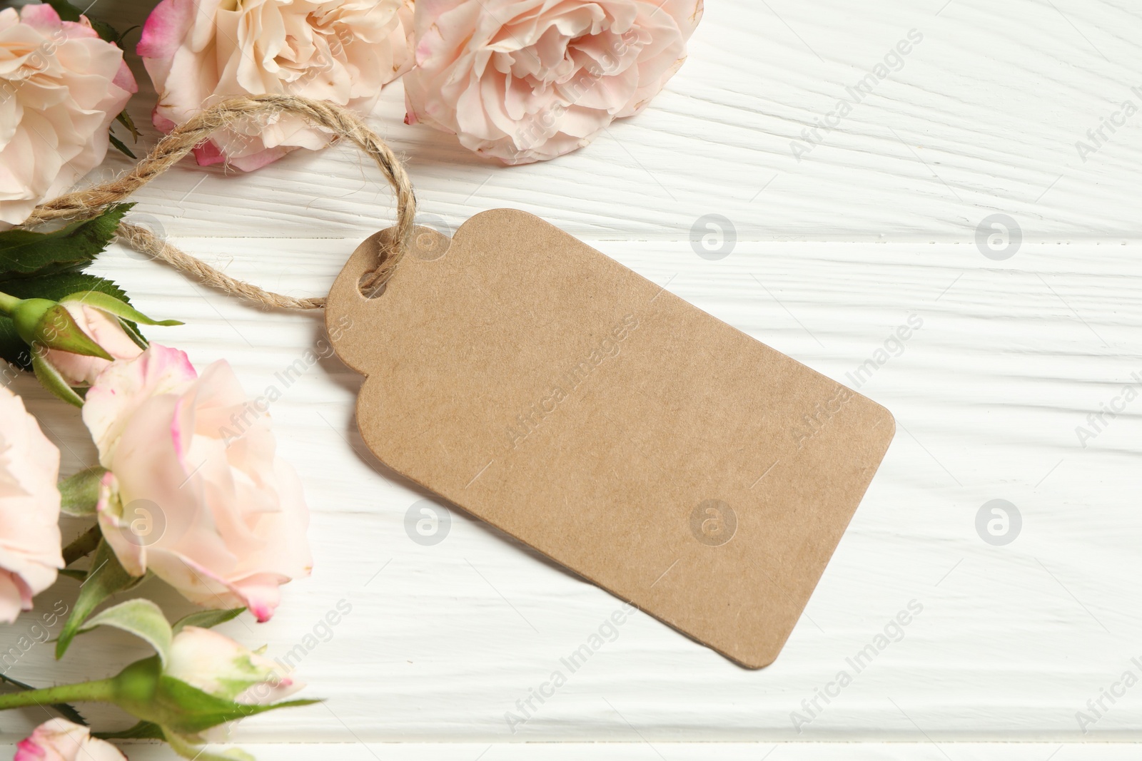 Photo of Happy Mother's Day. Beautiful flowers with blank card on white wooden table, flat lay