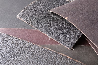 Many sheets of sandpaper as background, closeup