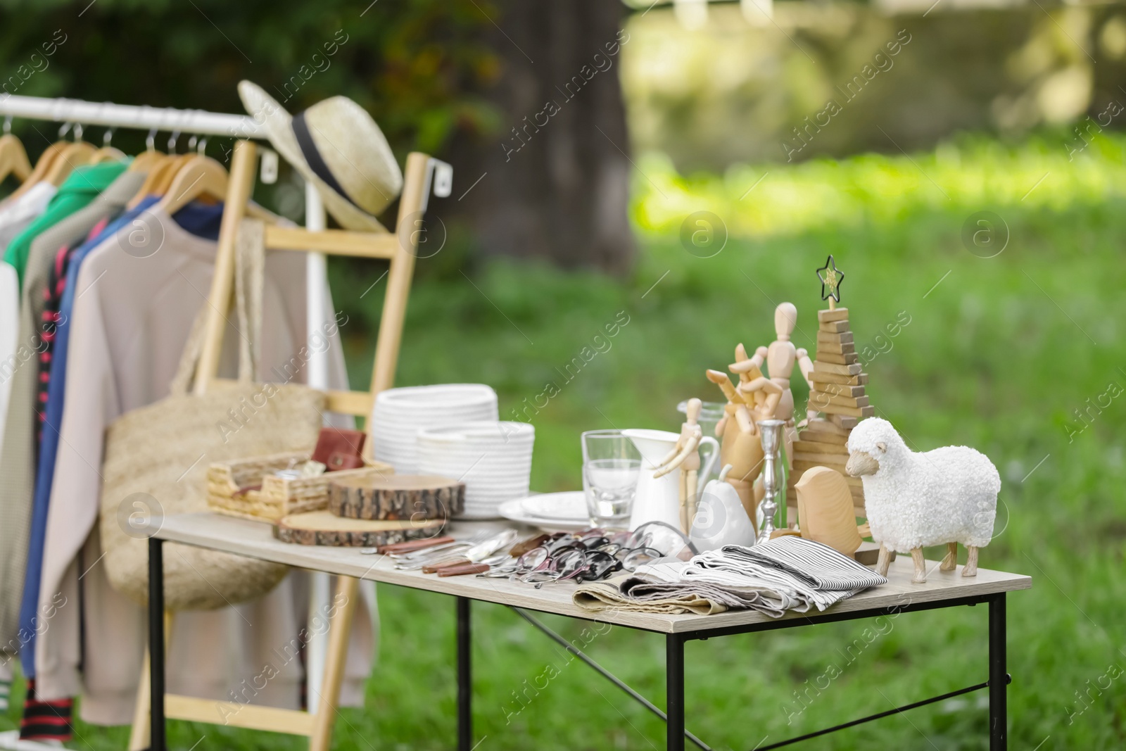 Photo of Many different items selling in yard. Garage sale