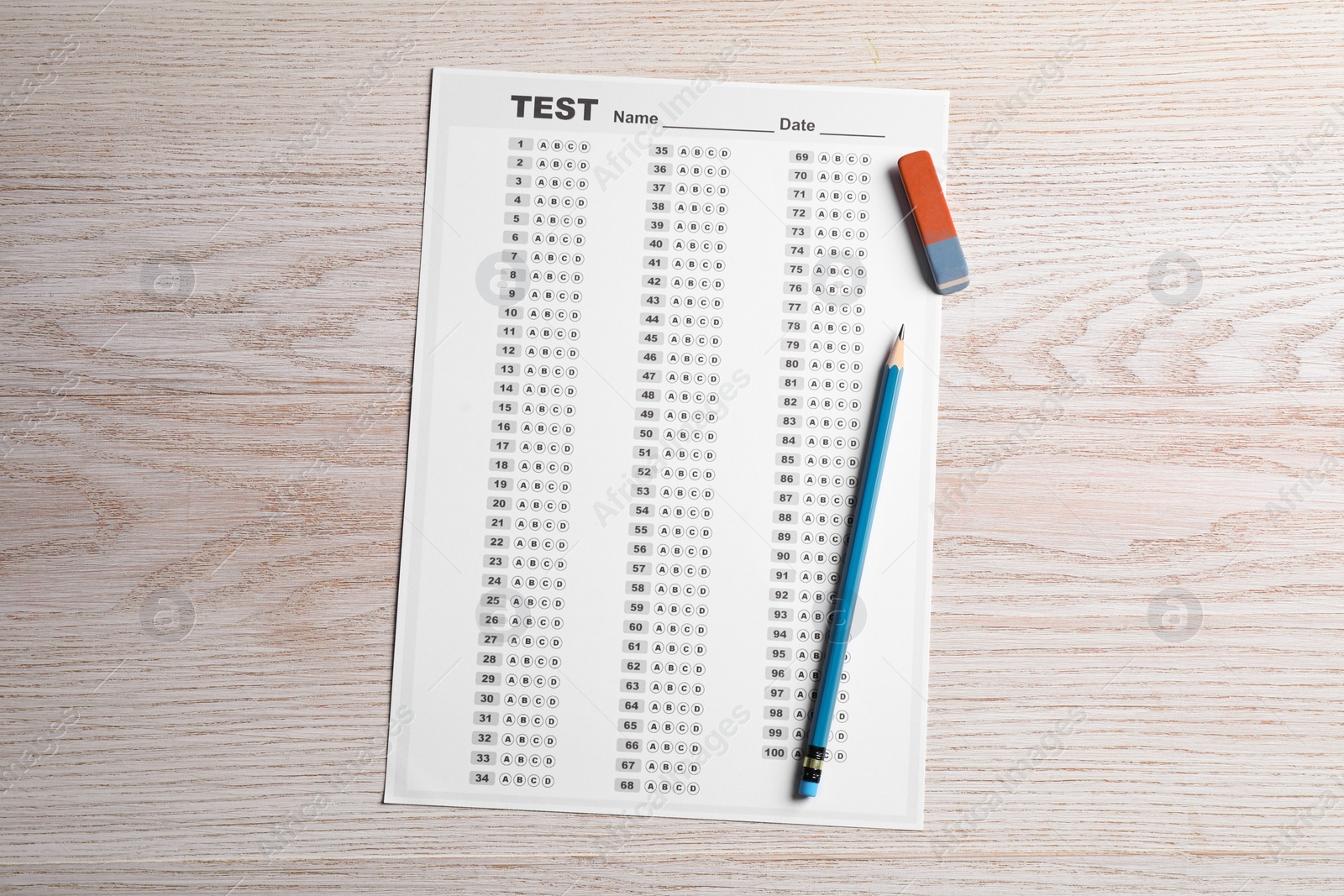 Photo of Answer sheet, pencil and eraser on wooden table, top view. Student passing exam