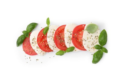 Photo of Tasty salad Caprese with mozzarella, tomatoes, basil and spices on white background, top view