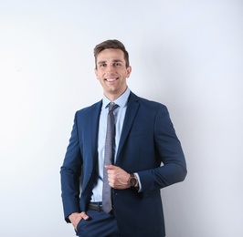 Photo of Handsome young man in suit on white background