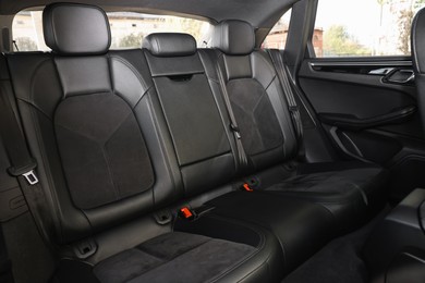 Clean leather seats inside of modern black car