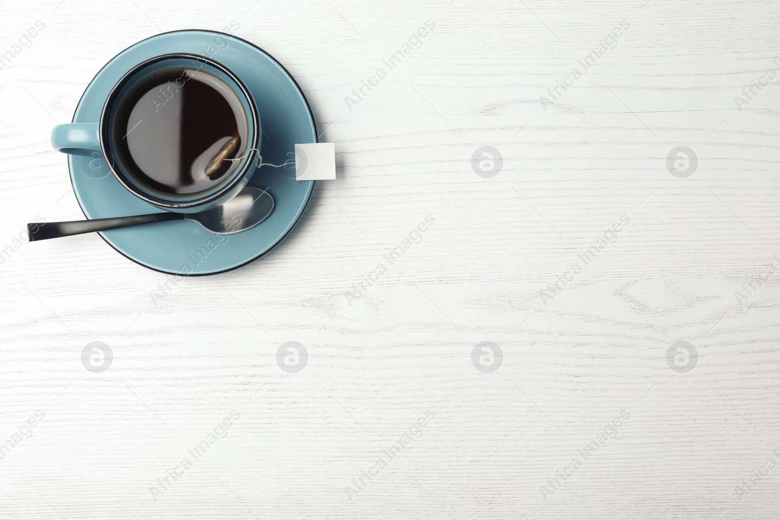 Photo of Cup of hot fresh tea on wooden background, top view. Space for text