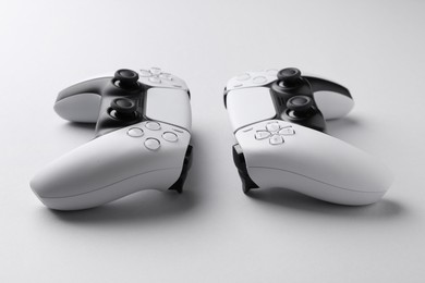 Wireless game controllers on light grey background