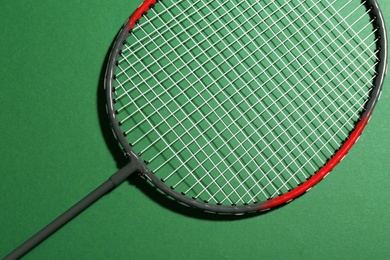 Photo of Badminton racket on green background, top view