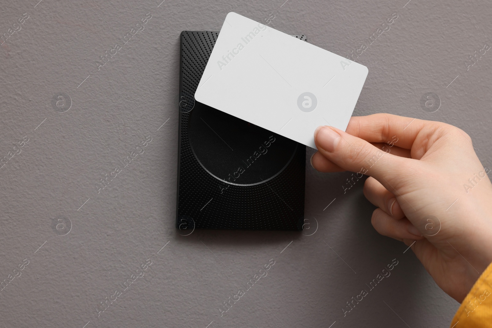 Photo of Woman opening magnetic door lock with key card, closeup. Home security