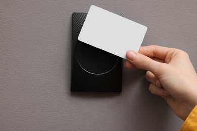 Photo of Woman opening magnetic door lock with key card, closeup. Home security