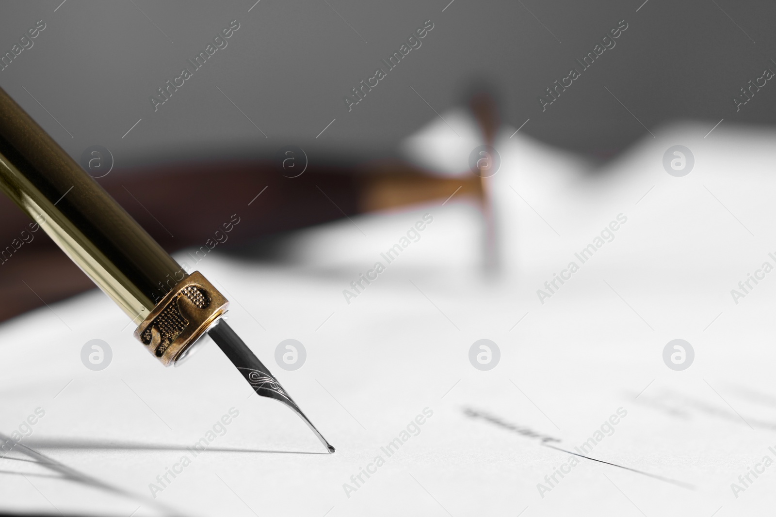 Photo of Writing on document with fountain pen, closeup and space for text. Notary contract