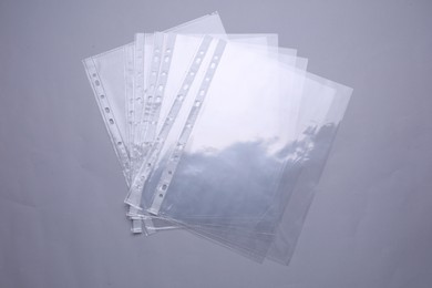 Photo of Empty punched pockets on light grey background, flat lay