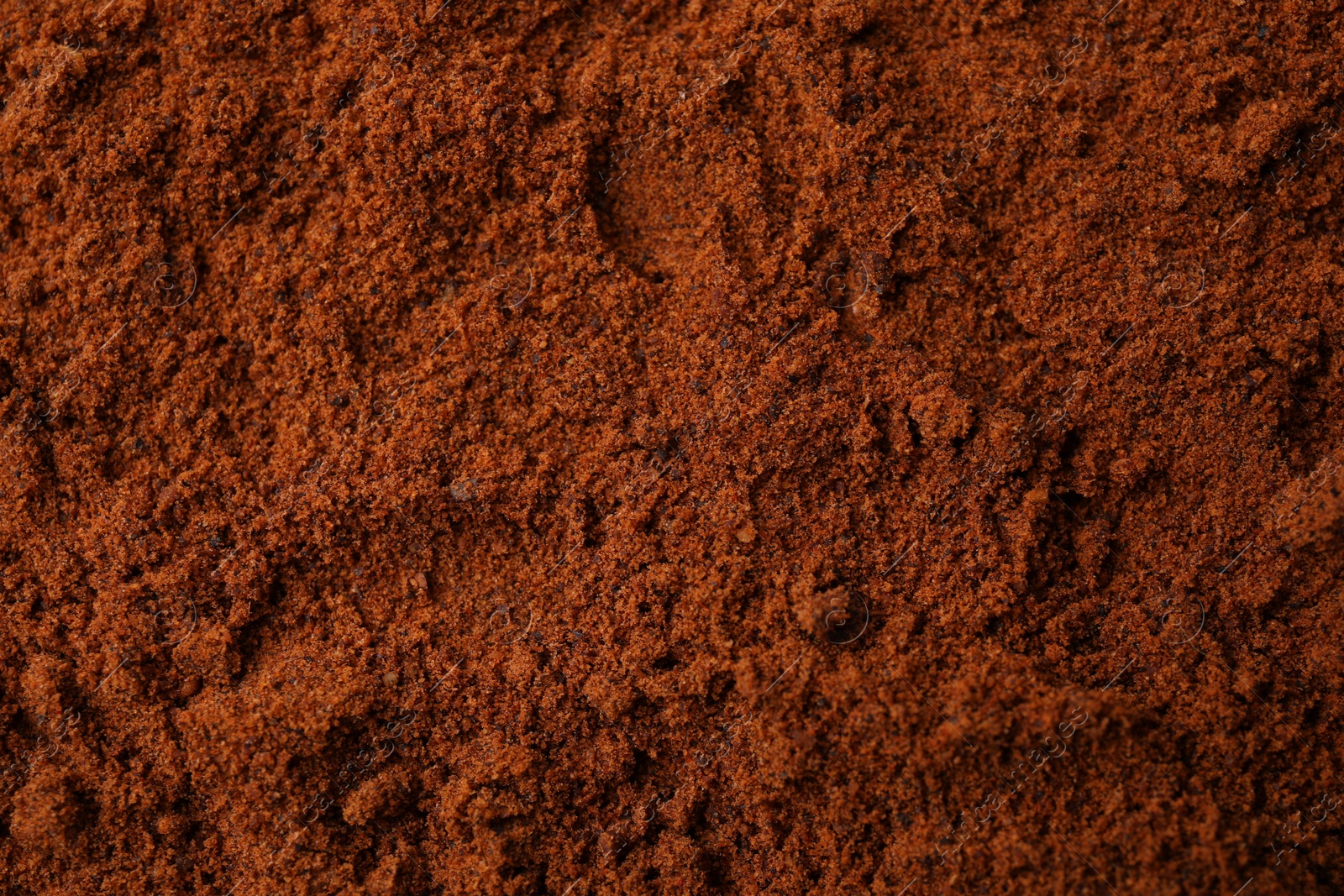 Photo of Heap of nutmeg powder as background, top view