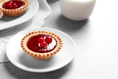 Photo of Tasty tartlet with jam on table, closeup