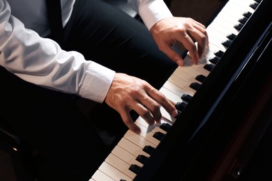 Photo of Man playing piano, above view. Talented musician
