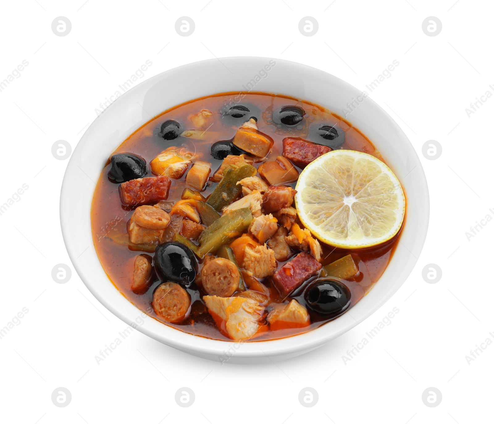 Photo of Meat solyanka soup with sausages, olives and vegetables in bowl isolated on white