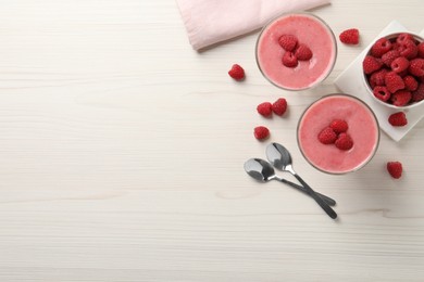 Delicious raspberry mousse on white wooden table, flat lay. Space for text