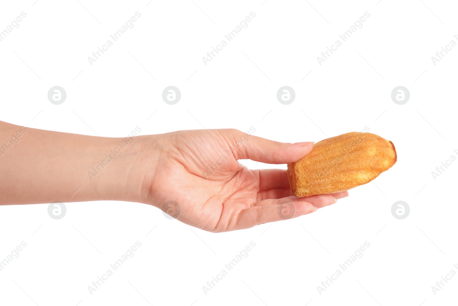 Photo of Woman holding delicious madeleine cake on white background, closeup