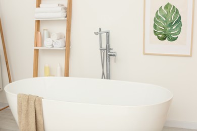 Photo of Stylish white tub in bathroom. Interior design