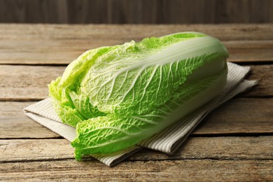 Photo of Fresh ripe Chinese cabbage on wooden table, closeup