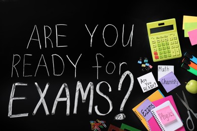Black chalkboard with phrase Are You Ready For Exams and different stationery, flat lay