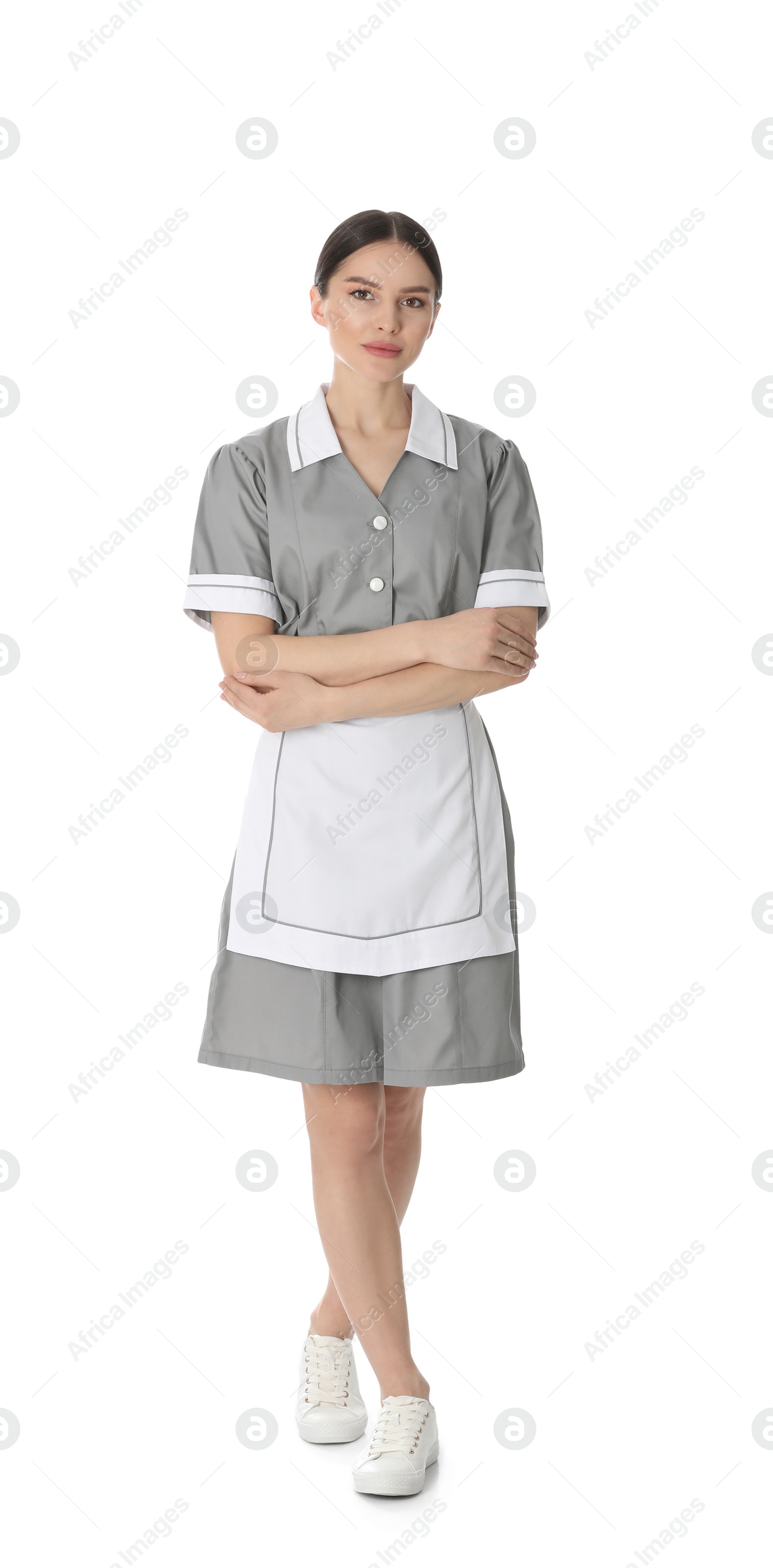 Photo of Young chambermaid in uniform on white background