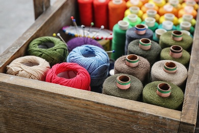 Box with color sewing threads, closeup