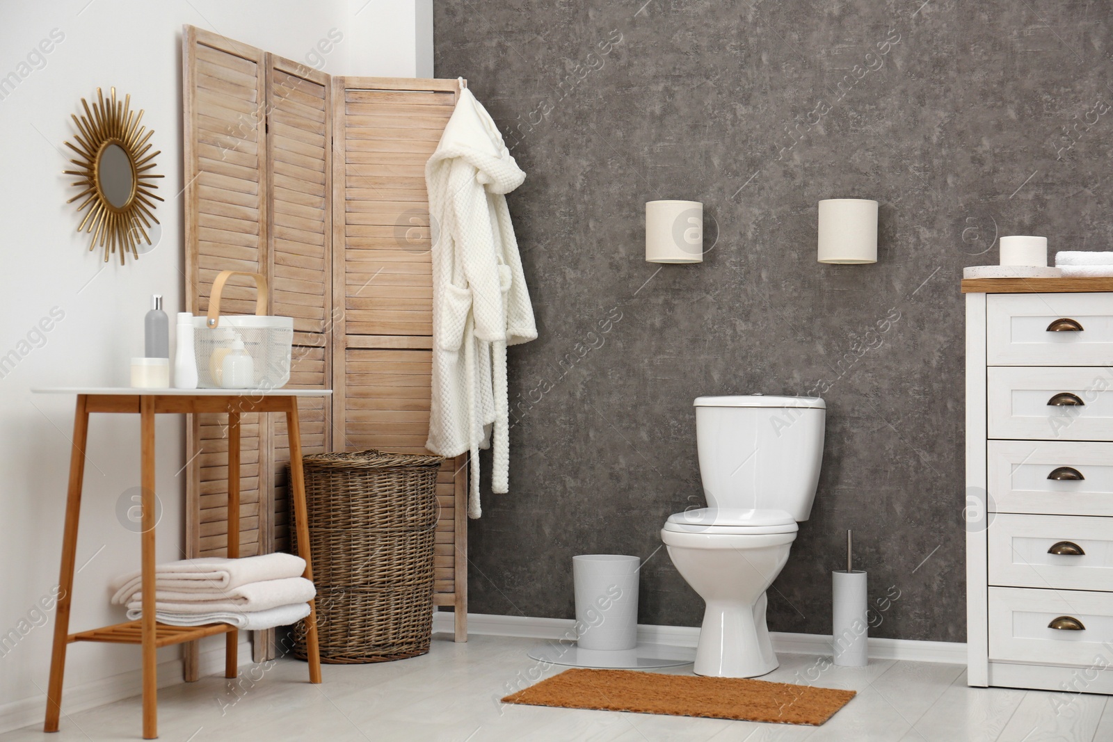 Photo of Ceramic toilet bowl in stylish bathroom. Idea for interior design