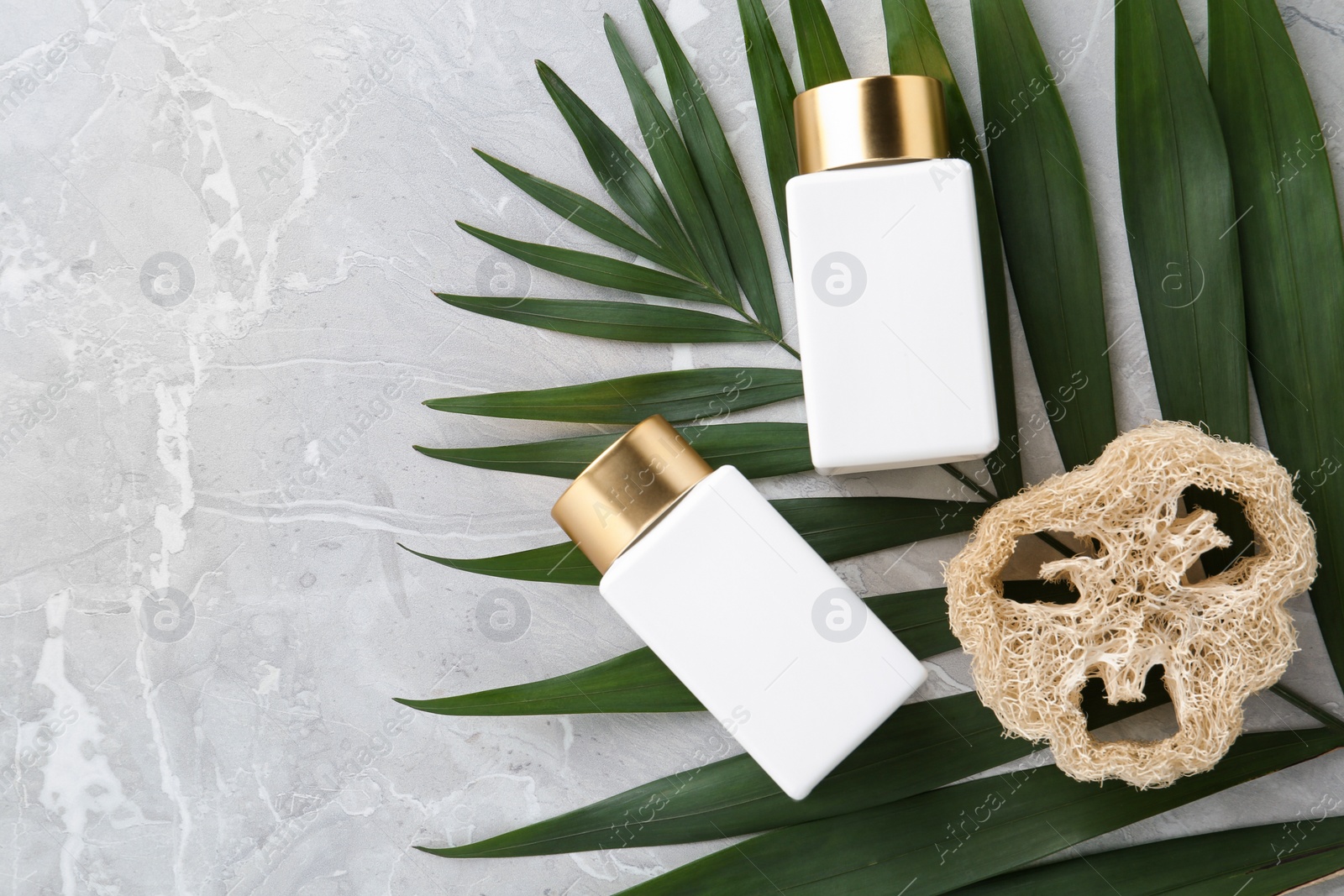 Photo of Flat lay composition with jars for cosmetic products on grey table. Spa supplies