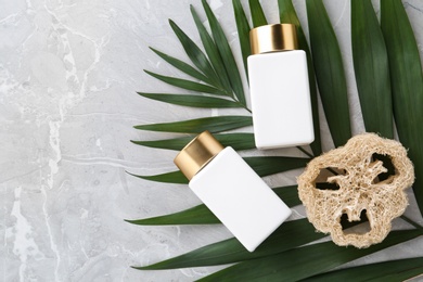 Photo of Flat lay composition with jars for cosmetic products on grey table. Spa supplies