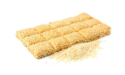 Delicious sweet kozinaki bar and sesame seeds on white background