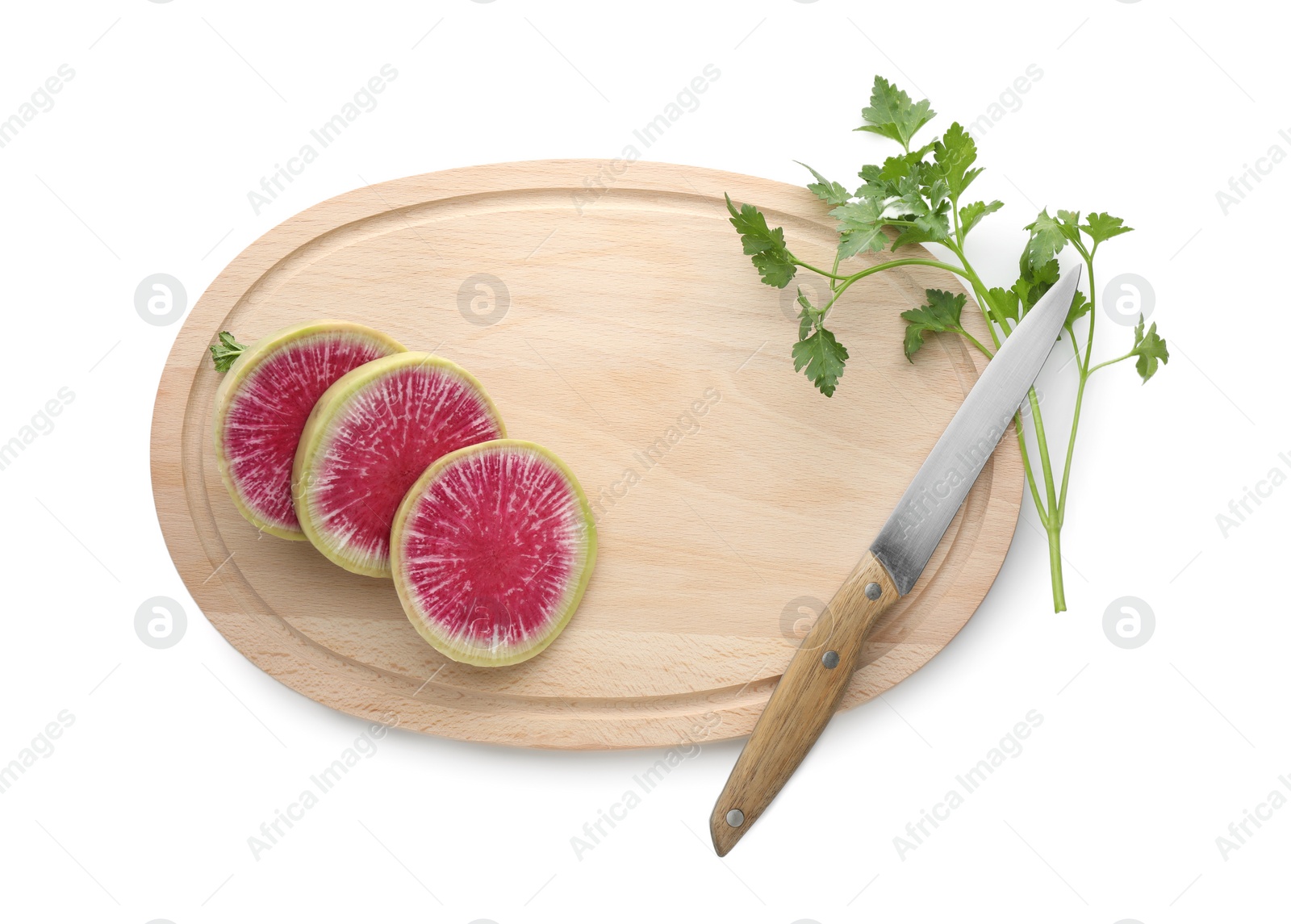 Photo of Wooden cutting board with fresh red meat radish, parsley and knife isolated on white, top view