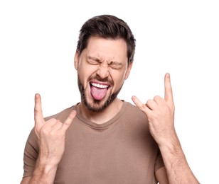Photo of Happy man showing his tongue and making rock gesture on white background
