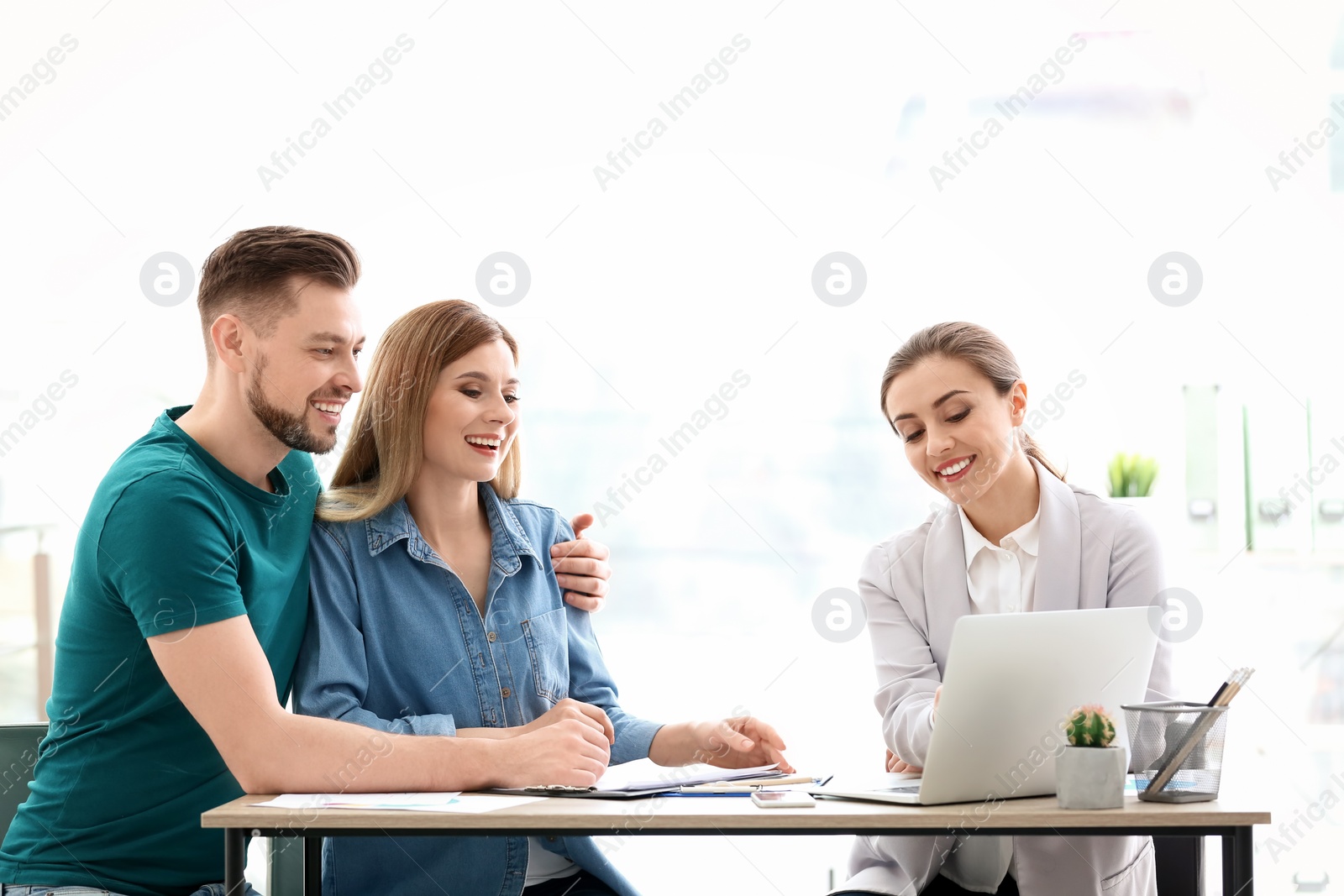 Photo of Young couple meeting with consultant in office