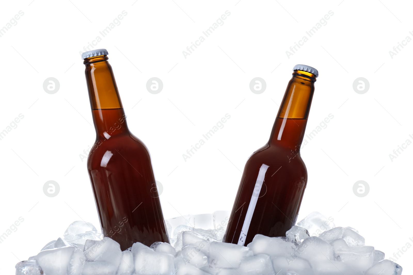 Photo of Bottles of beer on ice cubes against white background