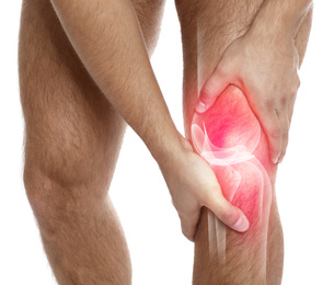 Image of Man suffering from knee pain on white background, closeup