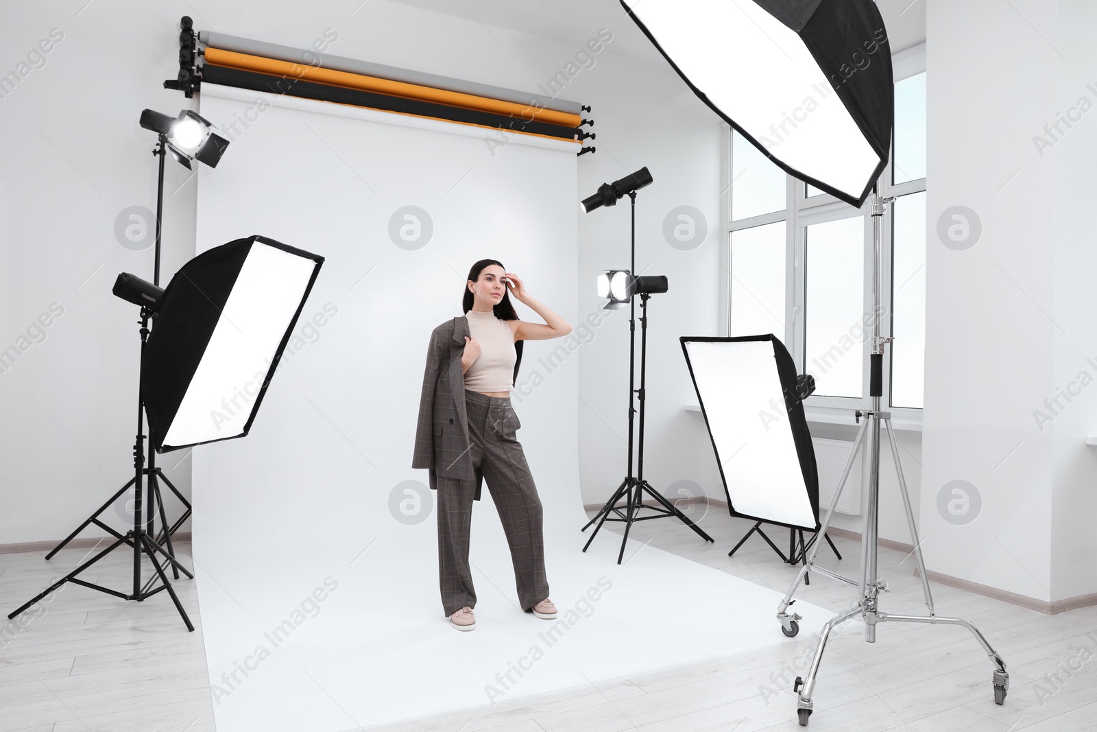 Photo of Beautiful young model posing in modern studio. Professional photo session