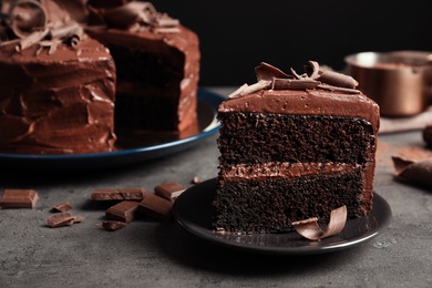 Plate with slice of tasty homemade chocolate cake on table