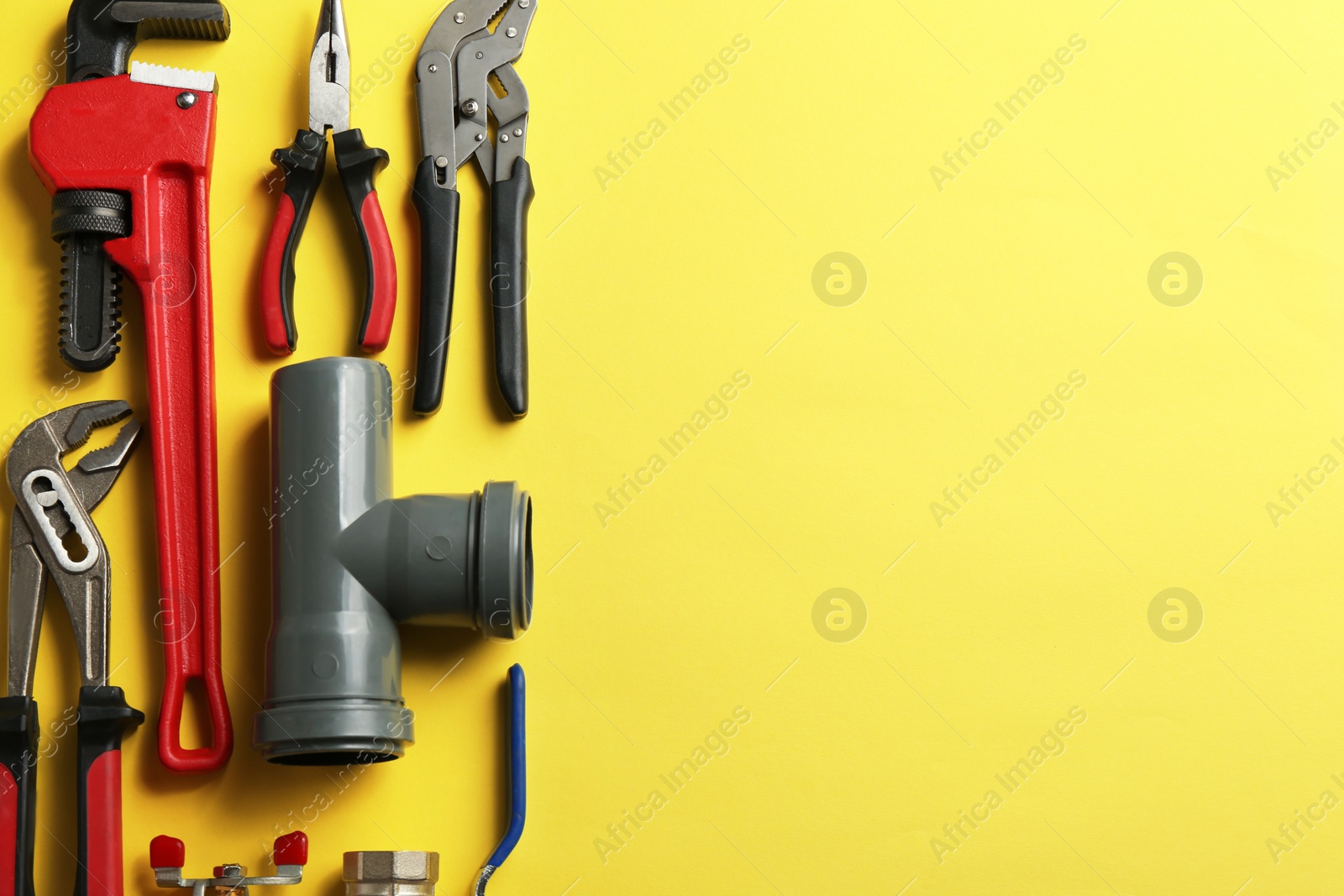 Photo of Flat lay composition with plumber's tools and space for text on color background