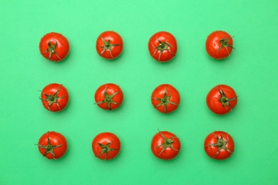 Photo of Flat lay composition with ripe tomatoes on color background