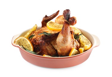 Photo of Chicken with orange slices in baking pan isolated on white