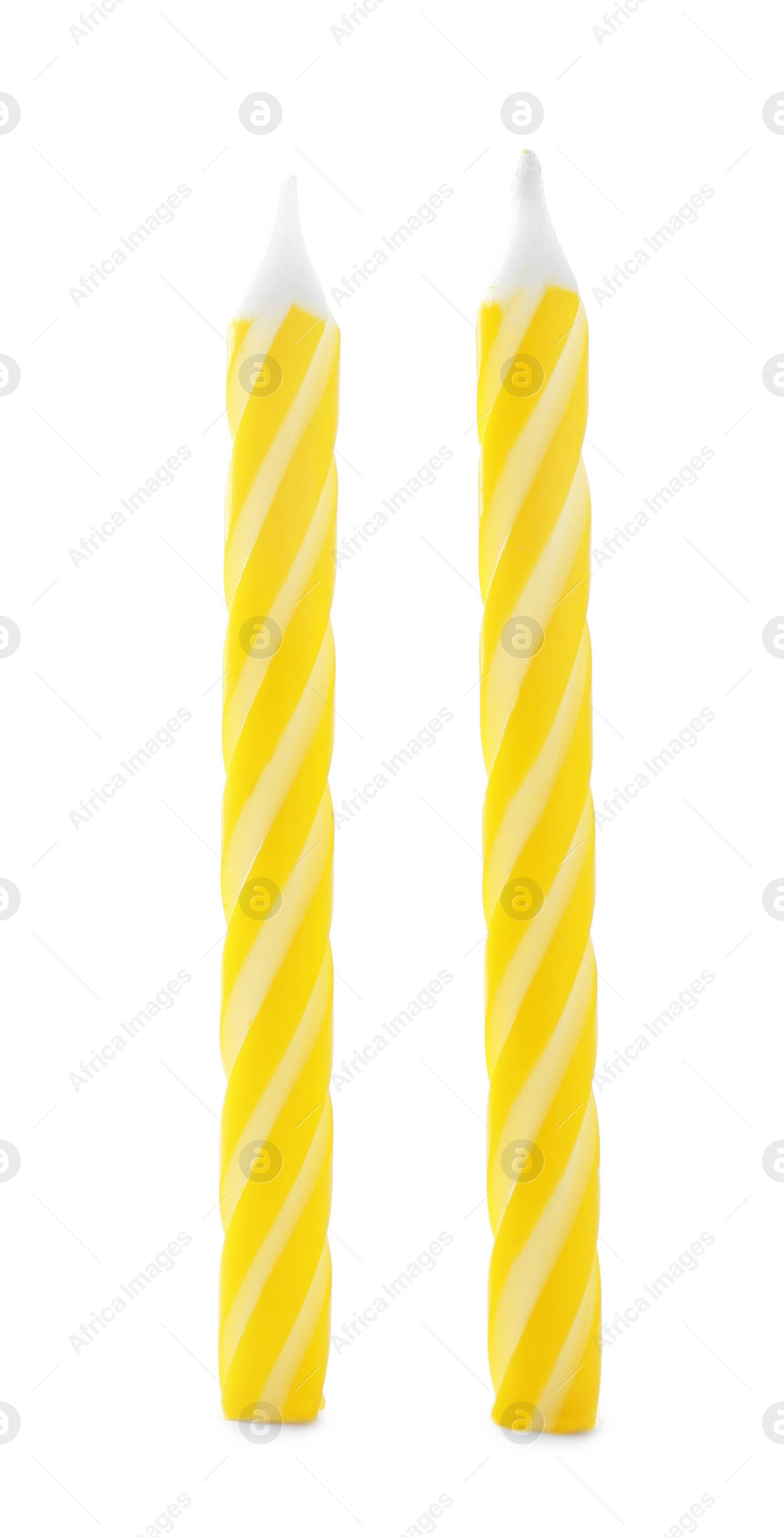 Photo of Yellow striped birthday candles isolated on white