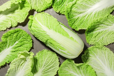 Photo of Fresh ripe Chinese cabbage and green leaves on table, top view