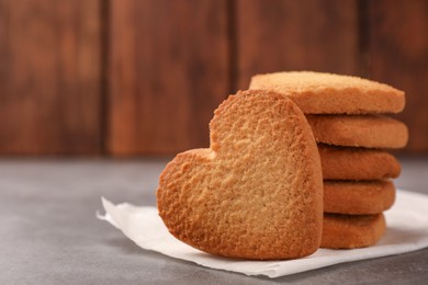 Photo of Heart shaped Danish butter cookies on grey table, closeup. Space for text