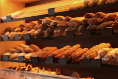 Photo of Blurred view of fresh pastries on counter in bakery store