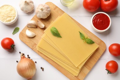 Ingredients for lasagna on white tiled table, flat lay