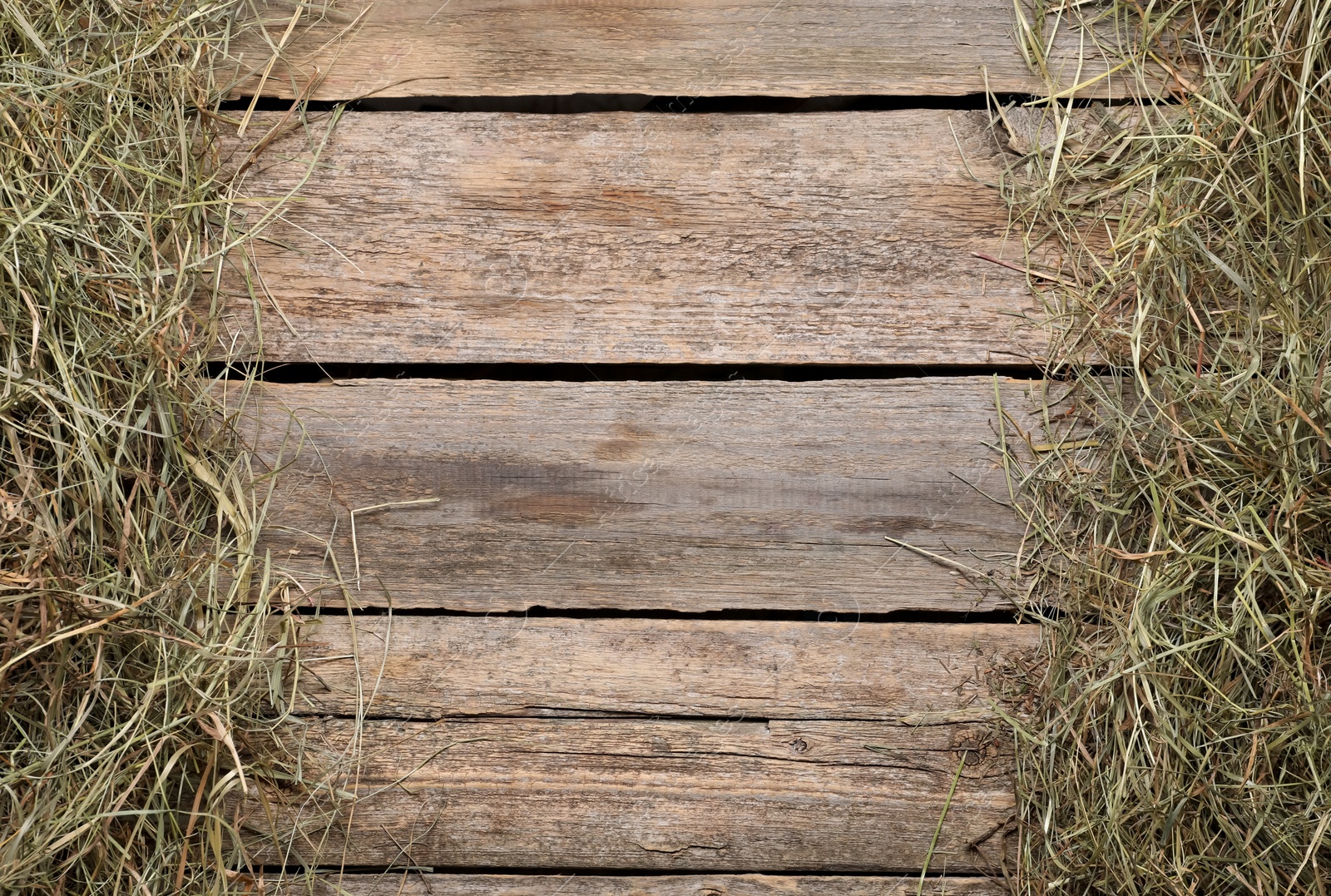 Photo of Frame made of dried hay on wooden table, top view. Space for text