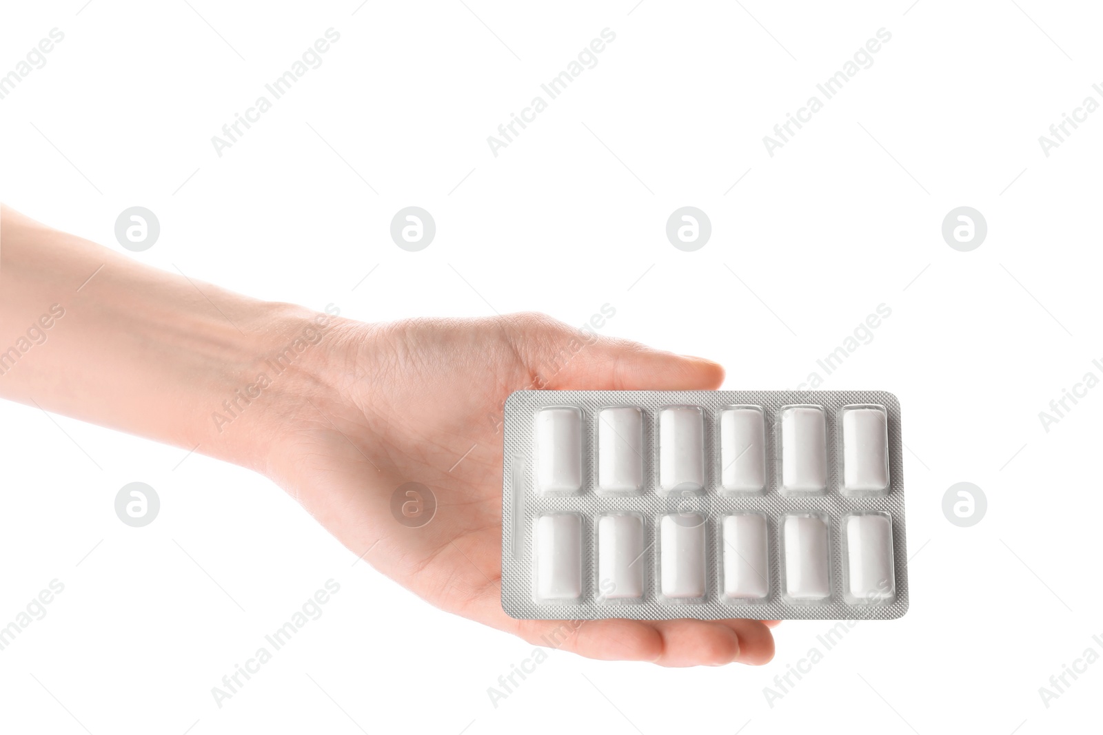 Photo of Woman holding blister with chewing gums on white background, closeup