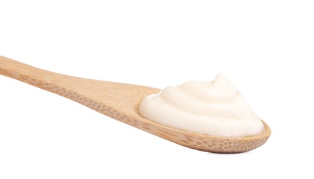 Delicious sour cream in wooden spoon on white background