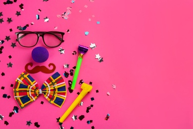 Photo of Flat lay composition with clown's accessories on pink background. Space for text